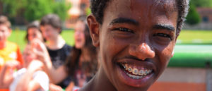 Young, sweaty man smiling with braces