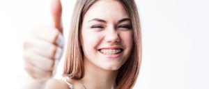 Teen girl smiling with an orthodontic appliance
